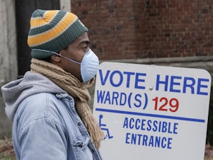 caption: A voter in line in Milwaukee during this month's Wisconsin election. Voting took place after multiple lawsuits to change absentee ballot deadlines, a possible preview of legal battles to come in 2020.