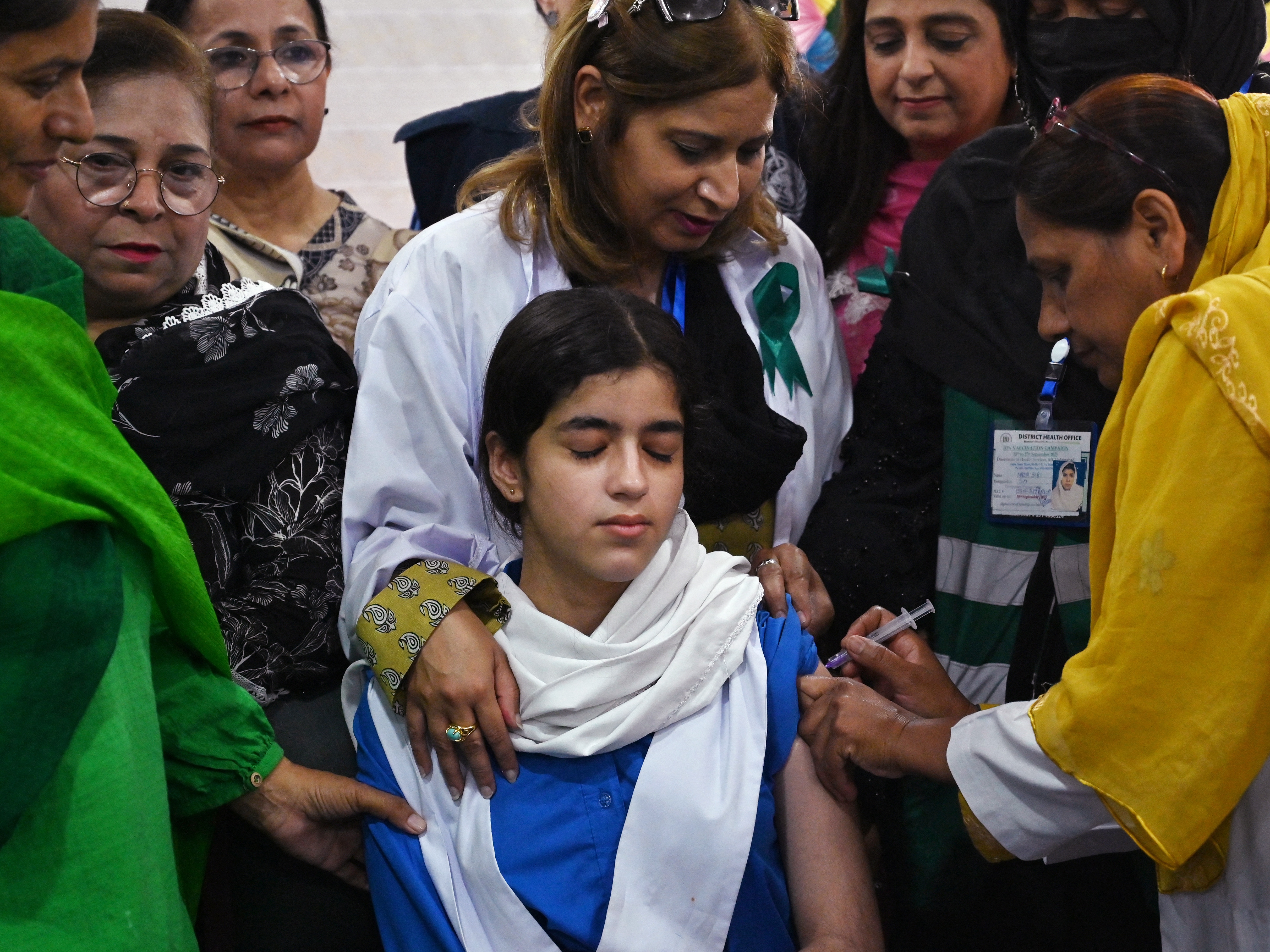 caption: A health worker administers the human papillomavirus (HPV) vaccine to a student in Islamabad, Pakistan on Sept. 24. The vaccine protects against cervical cancer. This year, a new one-dose strategy gained greater acceptance in Pakistan and other countries. Previously, the standard was three doses but years of testing have established that one dose is highly effective for younger girls and older girls can get the benefit from two doses.