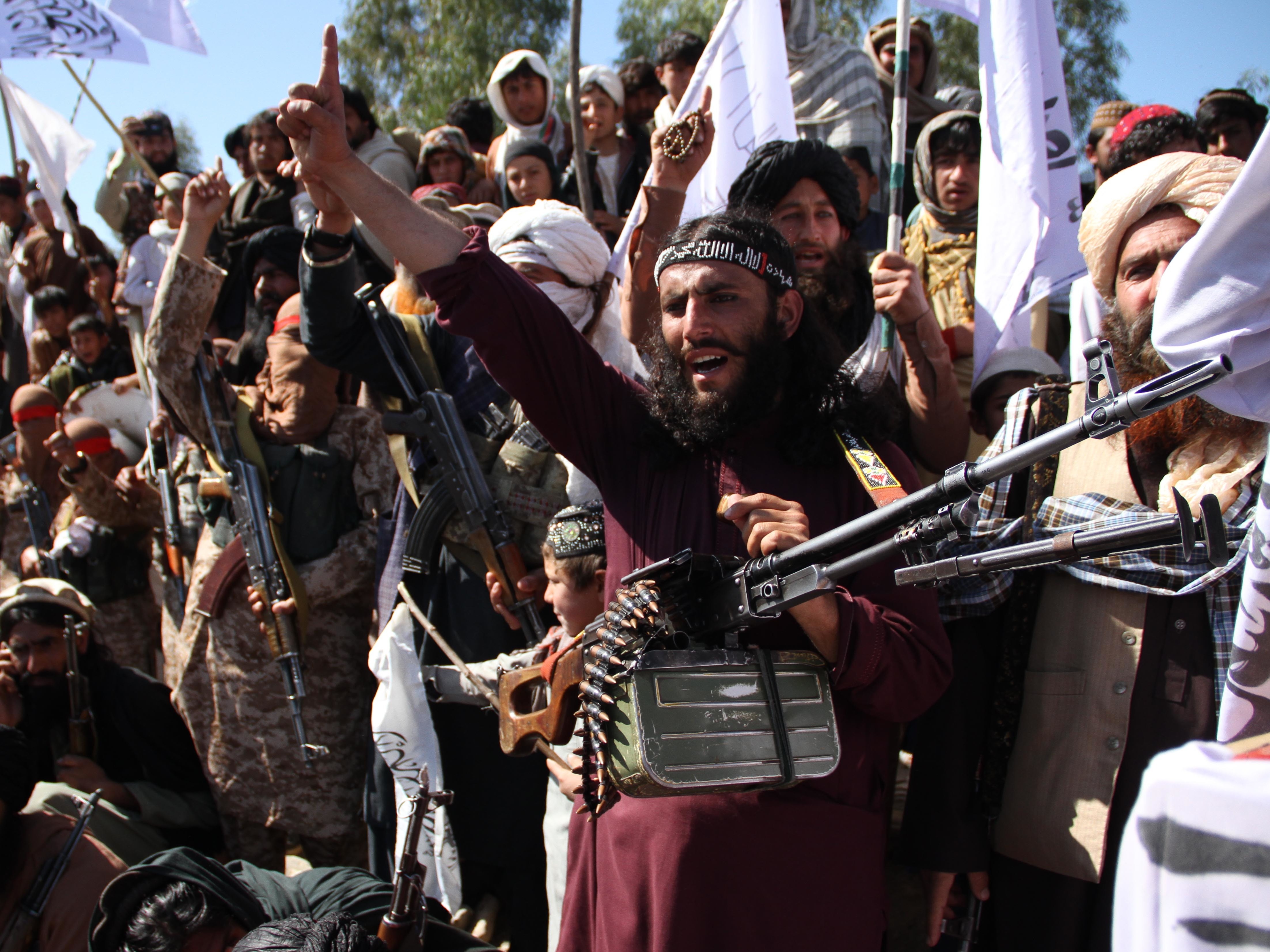 caption: Afghan Taliban fighters and villagers attend a gathering in Laghman province, Alingar district, in March 2020 as they celebrate the peace deal signed between the U.S. and the Taliban.
