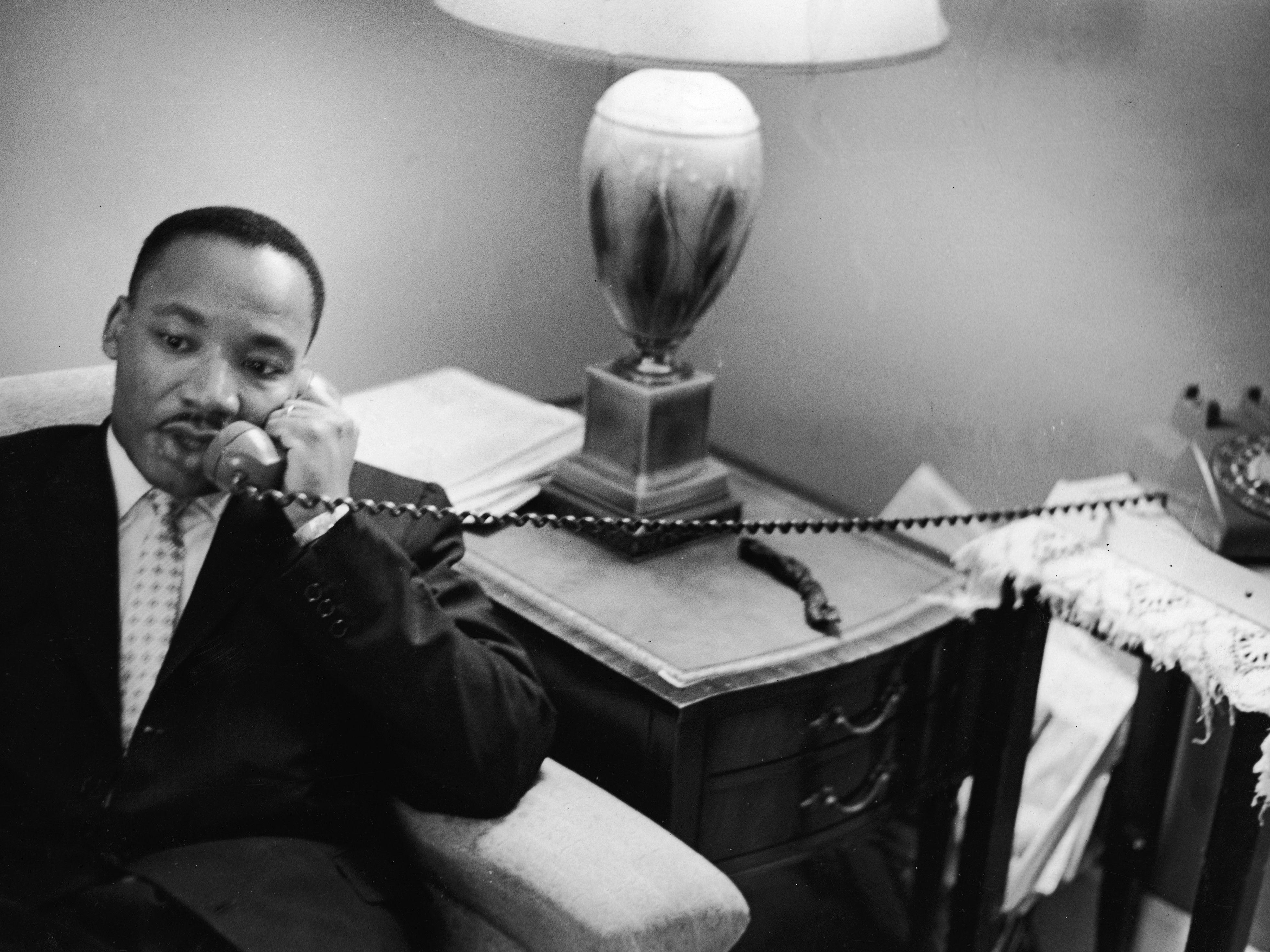 caption: The Rev. Martin Luther King Jr. speaks on the telephone after encountering a white mob protesting against the Freedom Riders in Montgomery, Ala., on May 26, 1961. On Monday, the Trump administration released a trove of records about King's assassination.