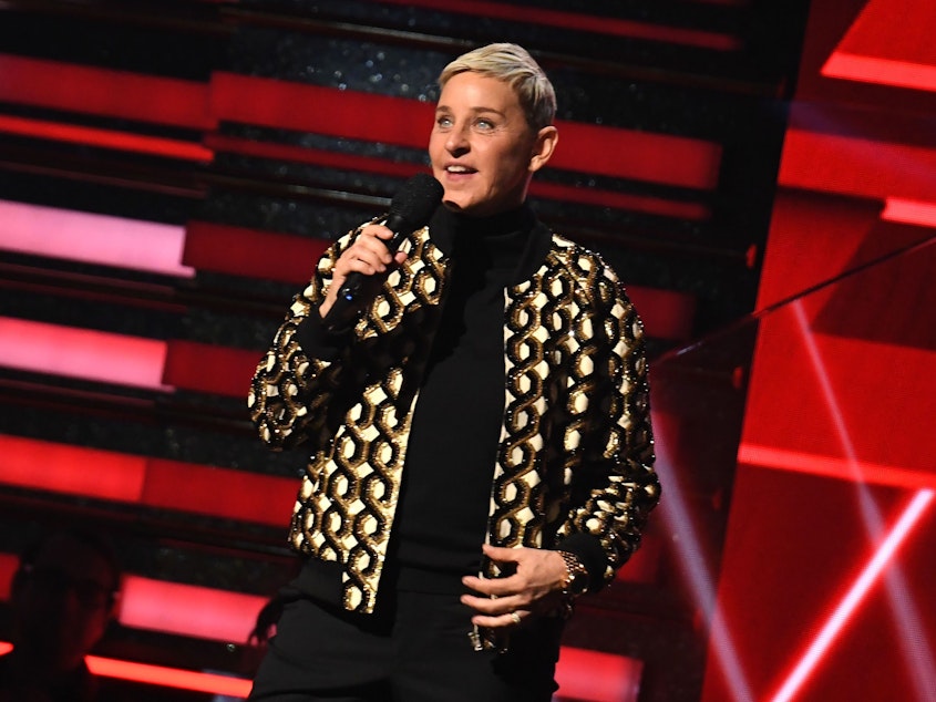 caption: Talk show host and comedian Ellen DeGeneres, on stage at the Grammy Awards in Jan. 2020.