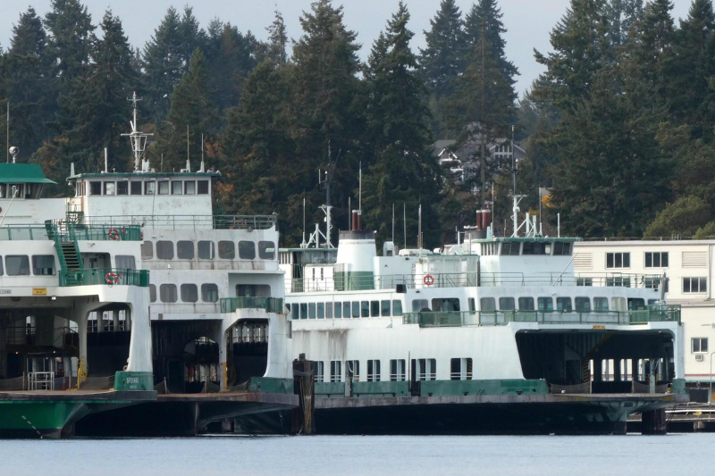 caption: The state ferries Klahowya (center right) and Hyak (left center) are taking up valuable space at the Eagle Harbor maintenance yard of Washington State Ferries. Both retired ferries have been for sale for more than four years. 