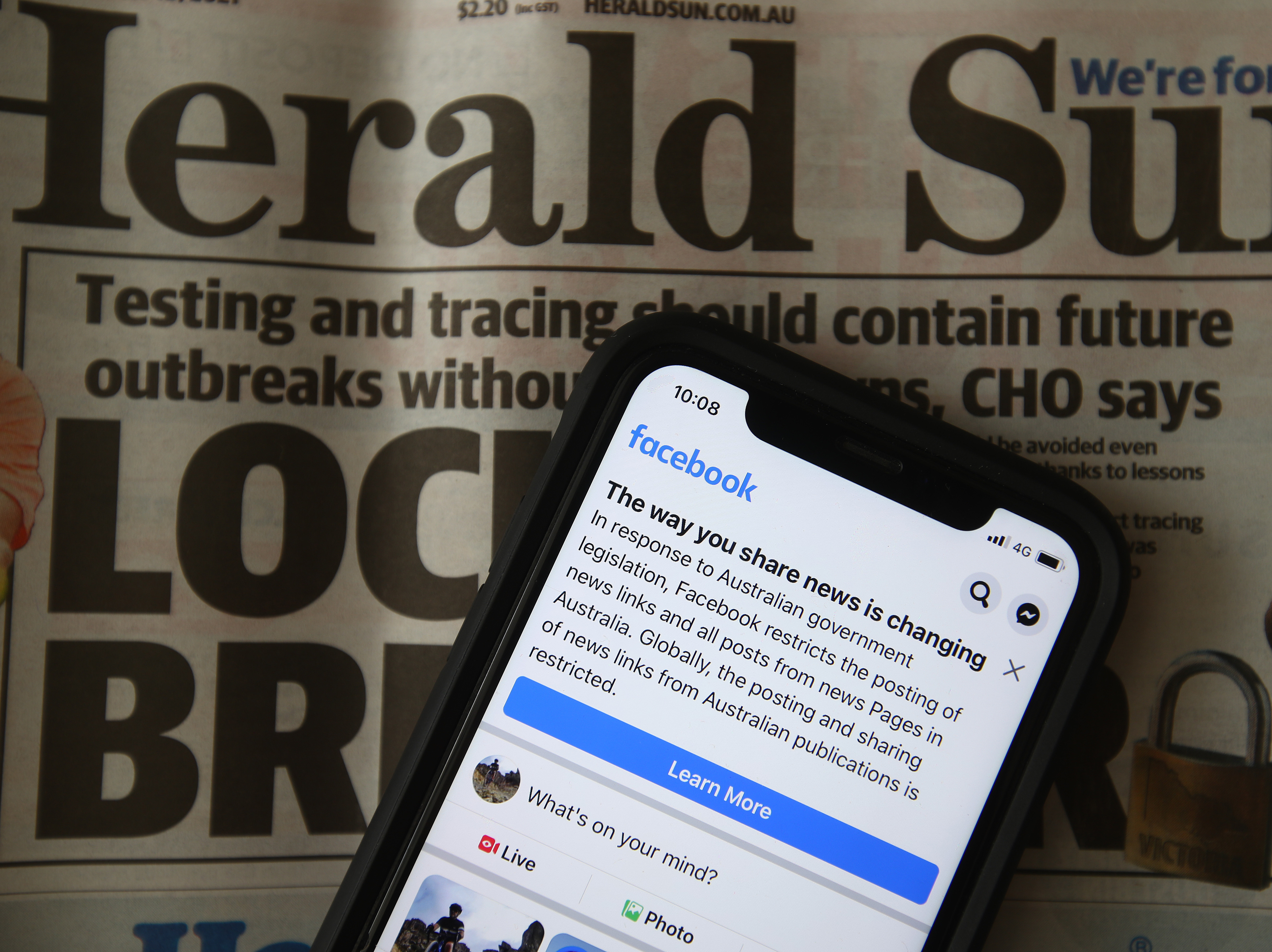 caption: An illustration of a message seen on Facebook mobile last month, when Facebook banned publishers and users in Australia from posting and sharing news content in a dispute over a new law requiring tech platforms to pay for it.