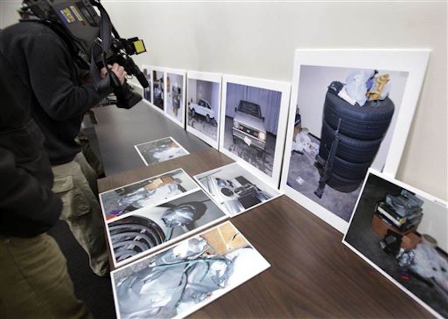 caption: A television photographer films pictures displayed at a news conference in Seattle, Monday, Nov. 9, 2009, of homemade bombs and other items found in the apartment of Christopher Monfort, the man accused of killing Seattle Police officer Timothy Brenton in 2009.