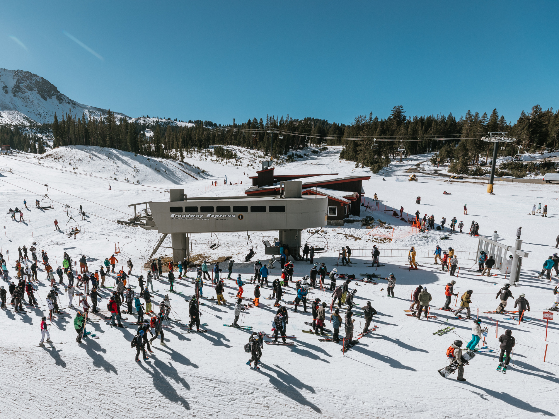caption: Skiers and snowboarders wait in a socially distanced lift line at Mammoth Mountain on Nov. 15.
