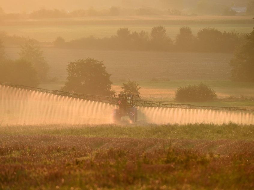 caption: Bayer says a settlement worth more than $10 billion will resolve most of the roughly 125,000 claims the company currently faces over its Roundup product. Here, a farmer sprays the glyphosate herbicide in northwestern France in September.