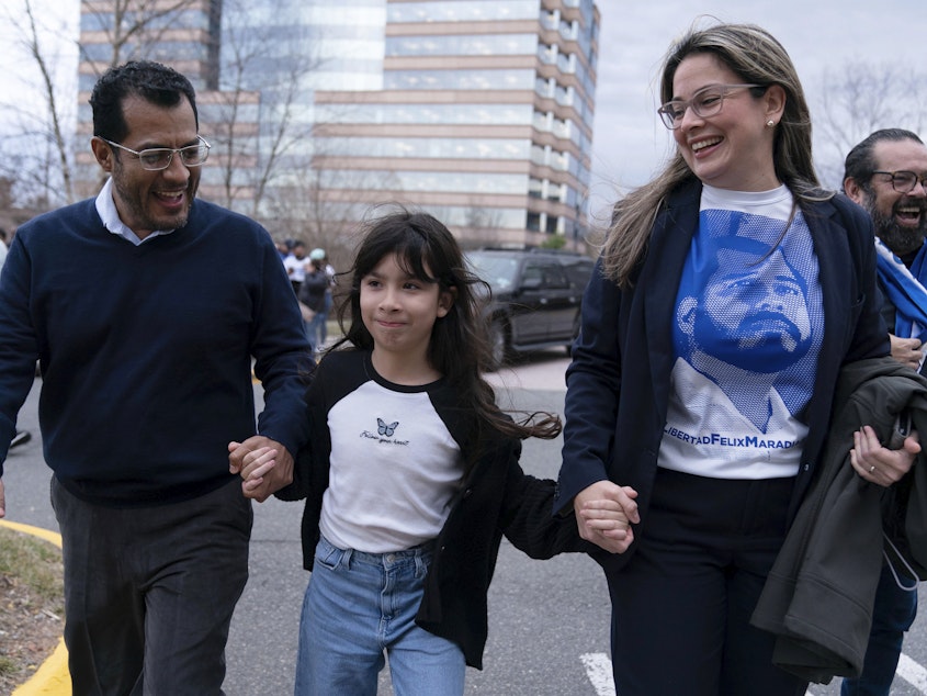caption: Former Nicaragua presidential candidate Felix Maradiaga reunits with his wife Berta Valle and his daughter Alejandra, walk together after Maradiaga arrived from Nicaragua at Washington Dulles International Airport, in Chantilly, Va., on Feb. 9.