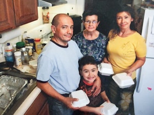caption: The Muñoz family (from left: Jorge, Justin, Blanca and Luz) prepares meals from their kitchen in 2010.