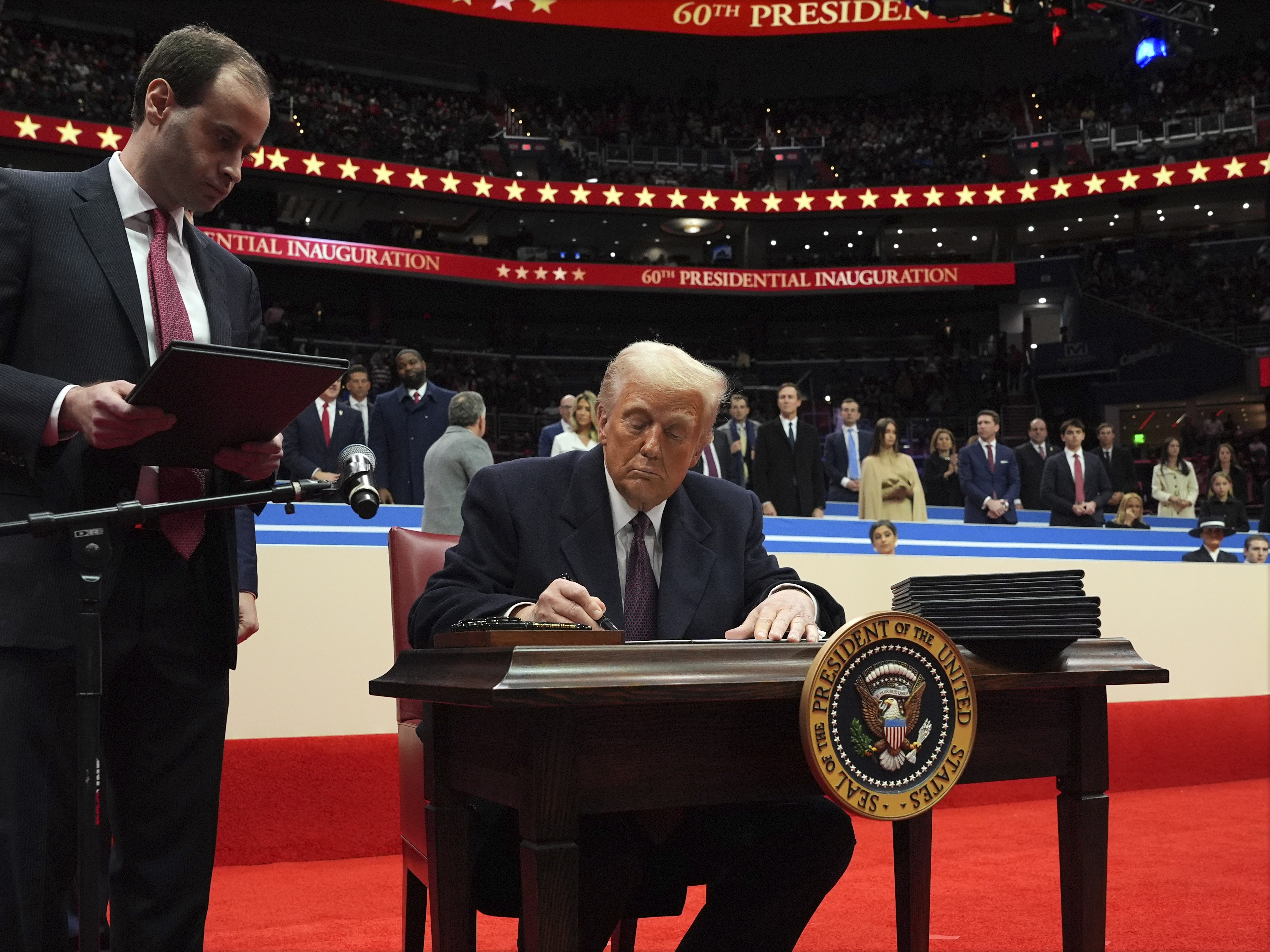 caption: President Trump signed a slew of executive orders Monday after his inauguration, including an order to begin the process of withdrawing the U.S. from the Paris climate agreement.