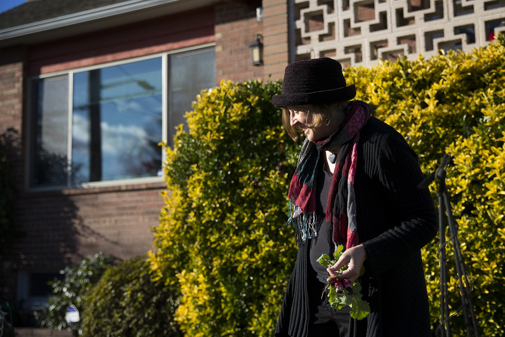 caption: Deb Seymour picks radishes from the garden in her front yard at her home on Wednesday, December 20, 2017, in Seattle. 