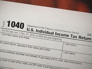A copy of an IRS 1040 tax form is seen at an H&R Block office in Florida in December 2017.