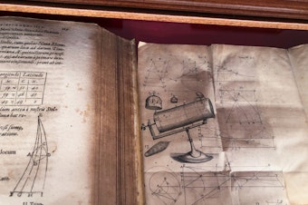 caption: Astronomical text books in Latin are displayed at the Vatican Observatory.