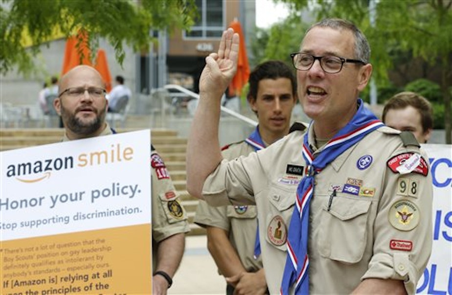 caption: Geoffrey McGrath delivers a petition bearing more than 125,000 signatures, urging Amazon to stop donating money to the Boy Scouts on May 21, 2014.