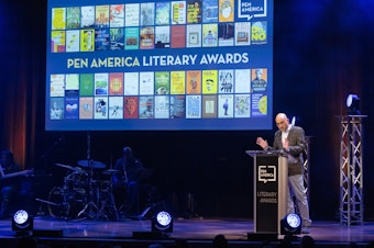 caption: Playwright Ayad Akhtar on stage at the 2023 PEN America Literary Awards in his role as then-president of the organization.