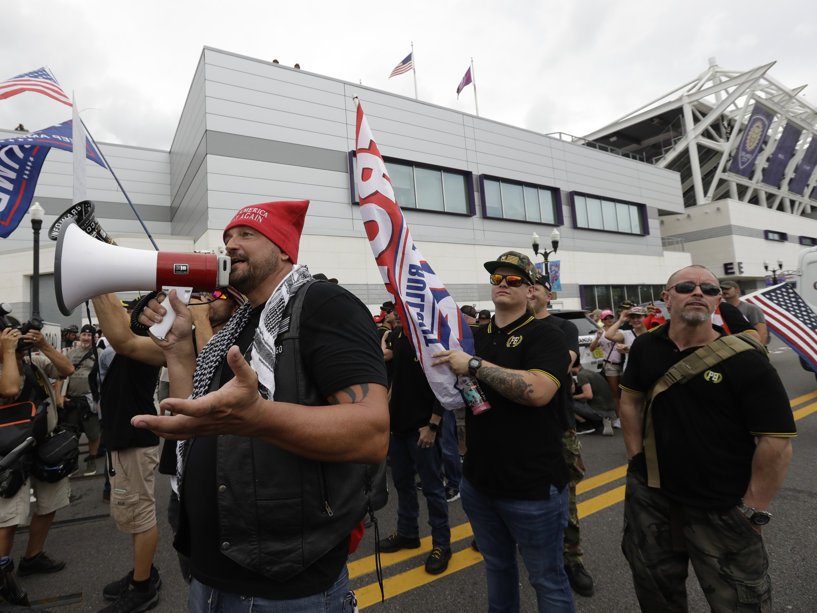 caption: A group from the Proud Boys confronts anti-Trump protesters outside Trump's 2020 campaign kickoff rally Tuesday in Orlando, Fla. The Proud Boys group is known for white nationalist and other extremist rhetoric.