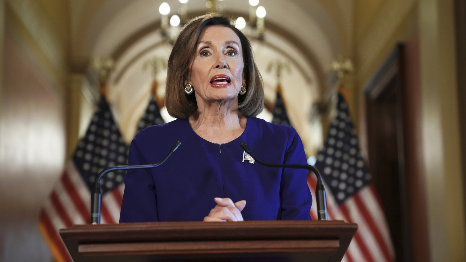caption: House Speaker Nancy Pelosi reads a statement announcing a formal impeachment inquiry into President Trump on Capitol Hill on Tuesday.