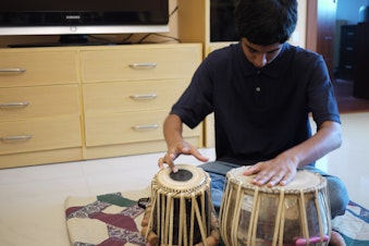 caption: Apurva Koti, 16, plays tabla drums in his living room in Hyderabad, India.  Apurva also plays electric guitar. Apurva and his family moved to India from Redmond, Washington in 2008. 
