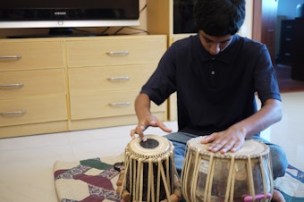 caption: Apurva Koti, 16, plays tabla drums in his living room in Hyderabad, India.  Apurva also plays electric guitar. Apurva and his family moved to India from Redmond, Washington in 2008. 