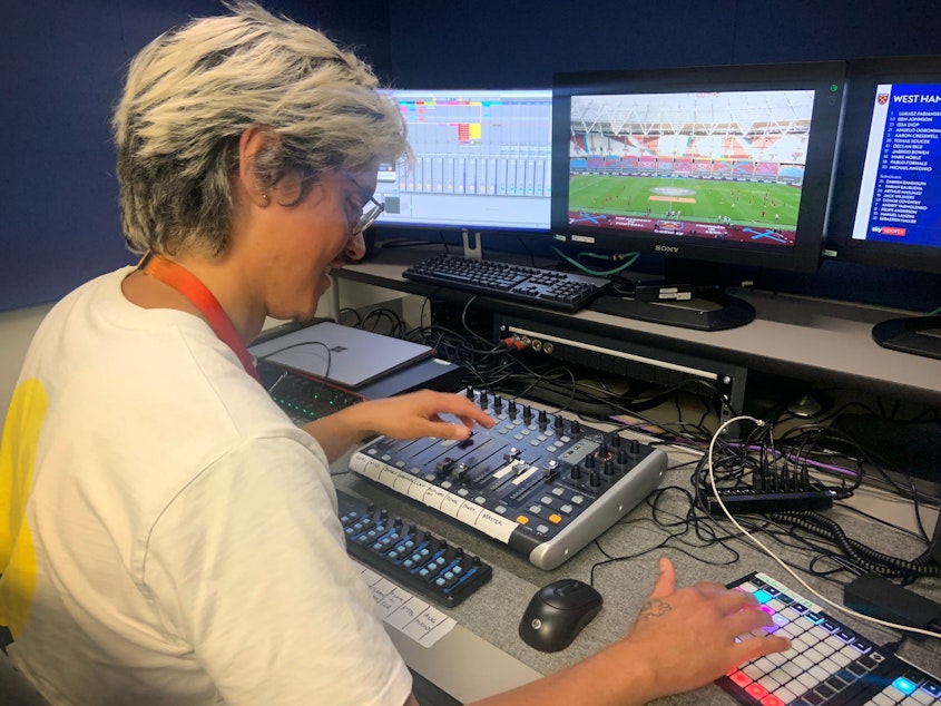 caption: Adam Peri, sound supervisor with the broadcaster Sky UK, mixes recorded fan sounds into a Premier League soccer match.