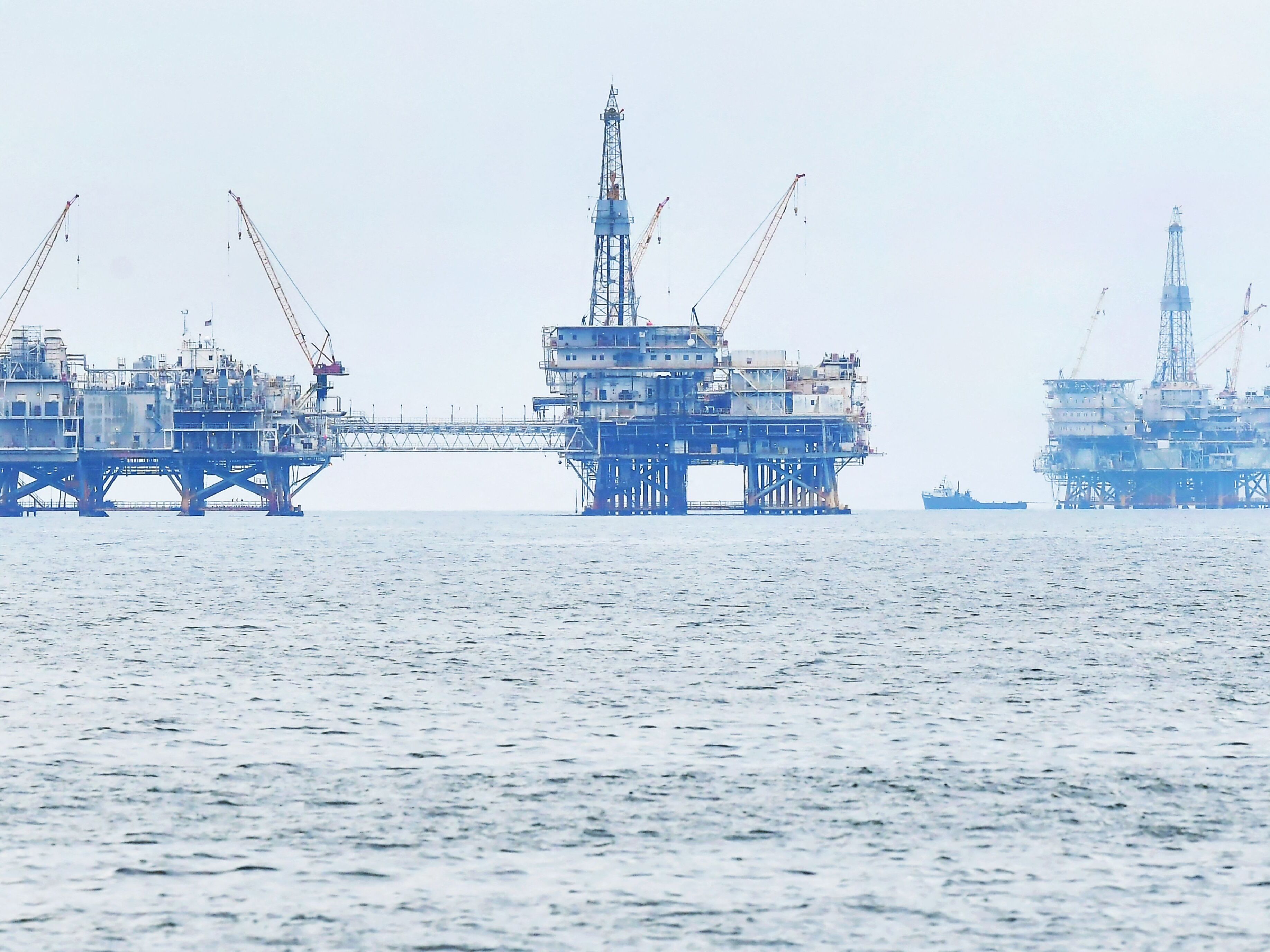 caption: Three oil platforms are seen in federal waters off the southern California coast in 2021.  President Biden has prohibited new oil and gas leases in more than 625 million acres of federal ocean; existing leases are not affected.