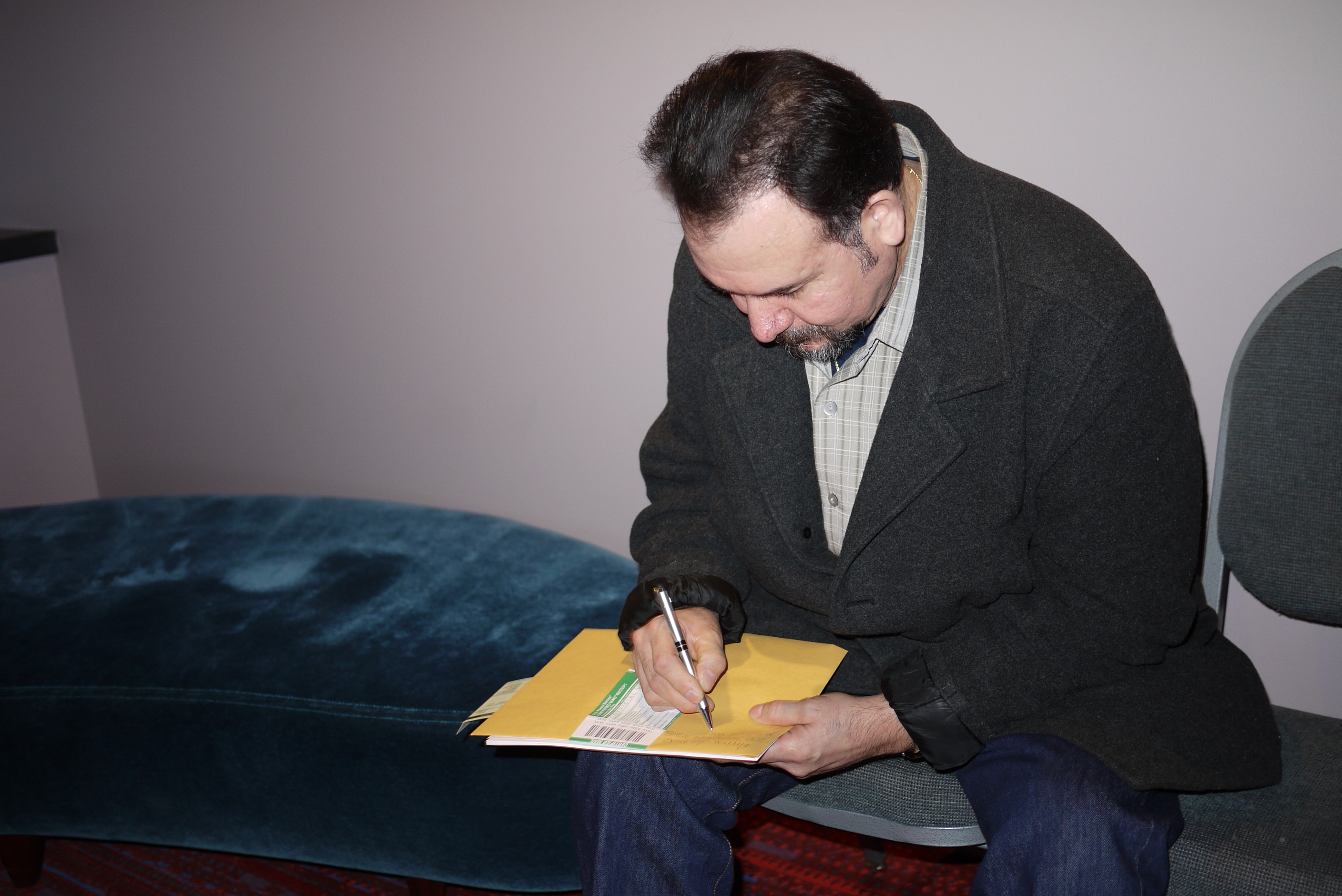caption: Armando Diaz of Mill Creek completes his citizenship application.