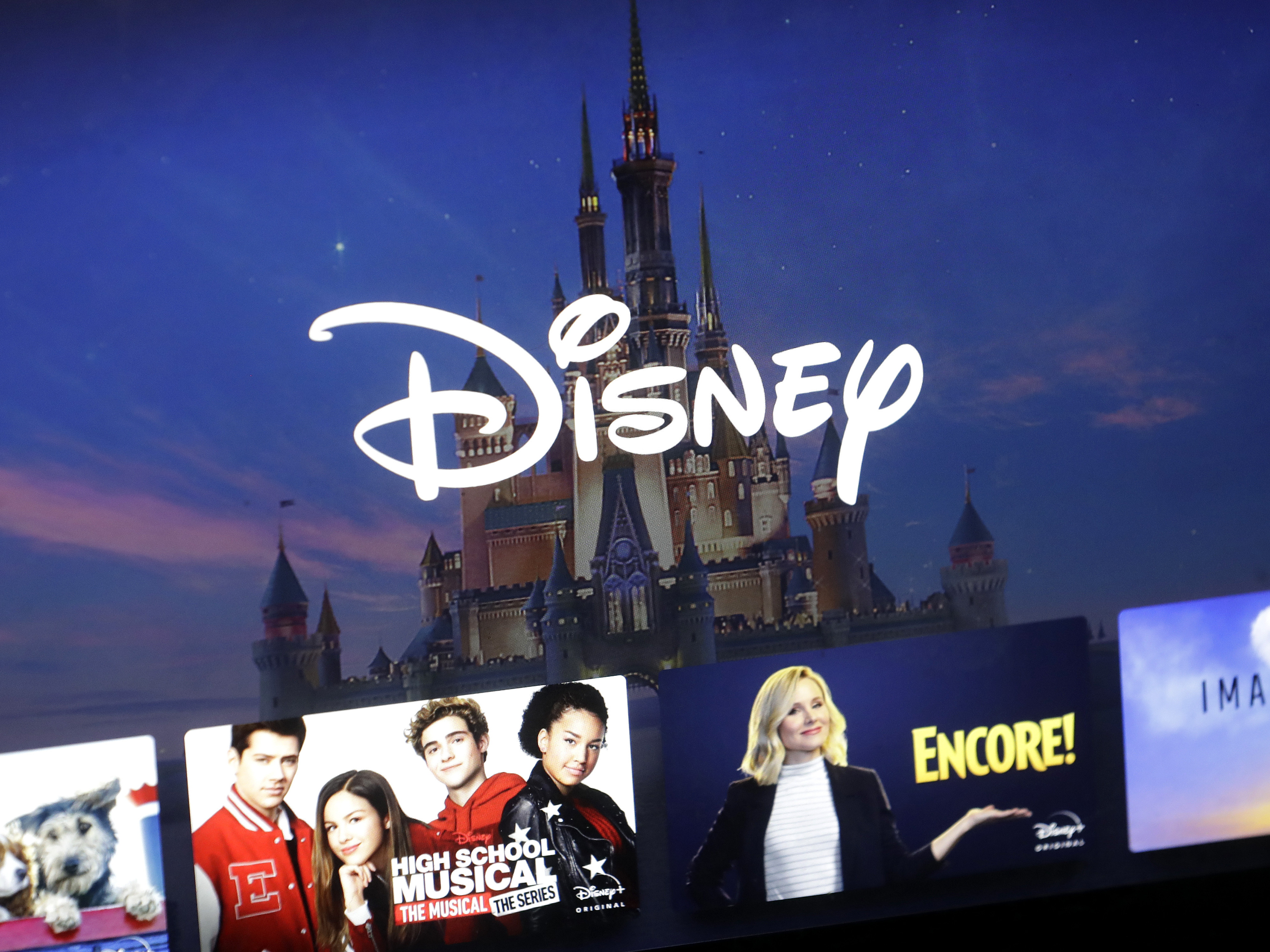 caption: In this Wednesday, Nov. 13, 2019, file photo, a Disney logo forms part of a menu for the Disney Plus movie and entertainment streaming service on a computer screen in Walpole, Mass.