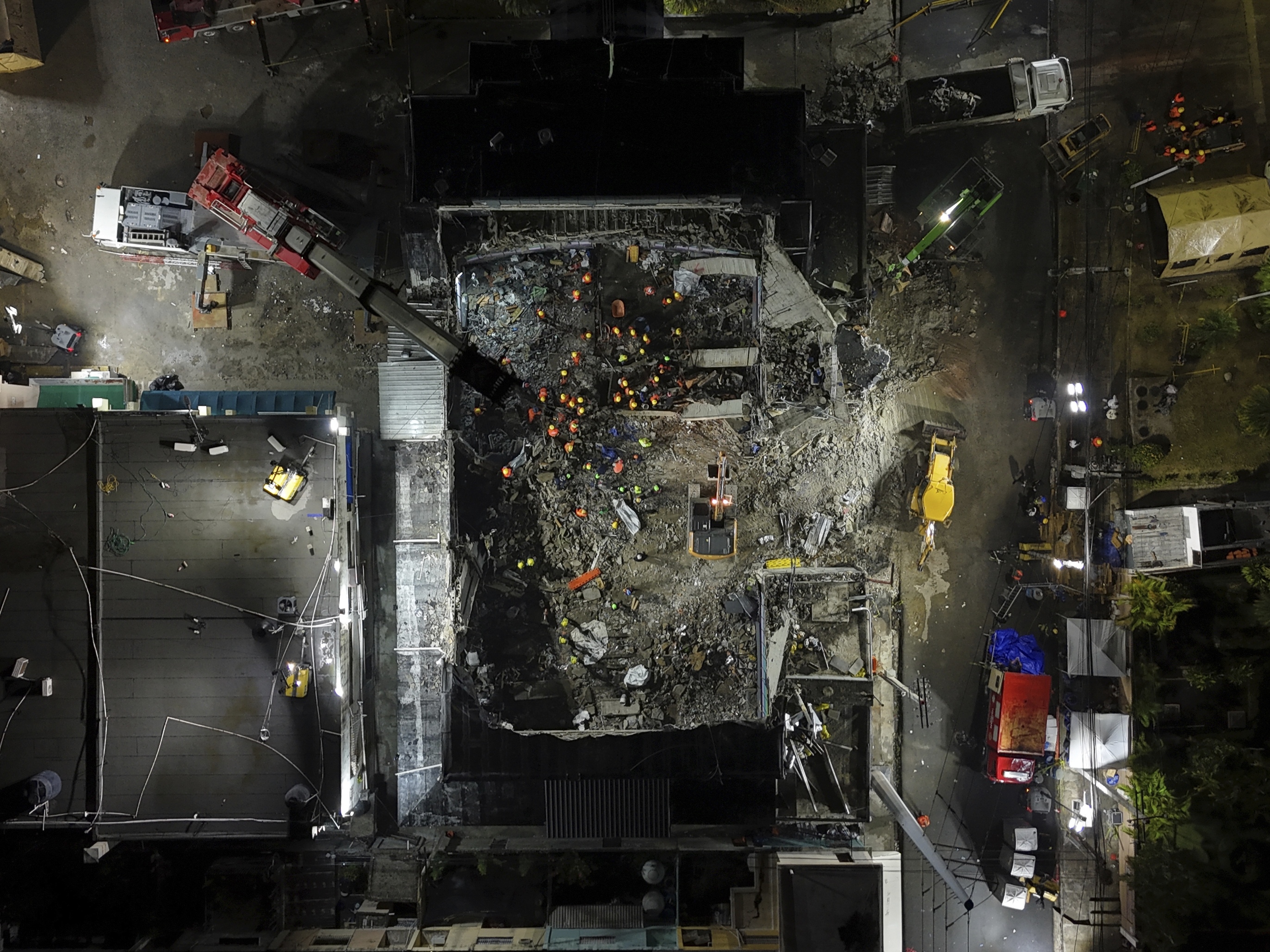 caption: Rescue workers search for bodies at the Jet Set nightclub after its roof collapsed during a merengue concert in Santo Domingo, Dominican Republic in April.