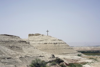 caption: Jesus' baptism site overlooking the Jordan River, 6 miles north of the Dead Sea. The Jordanian site includes the spot where UNESCO says Jesus was believed to have been baptized, now inland after the river changed course, as well as Elijah's Hill, where tradition says the Prophet Elijah ascended to heaven in a flaming chariot.