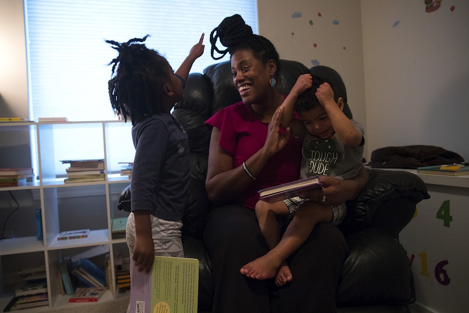 caption: Biggest Carbon Loser contestant Bernadette Merikle, center, reads with her children, Julia, 4, and John, 2, on Wednesday, February 12, 2020, at their home in Snoqualmie.