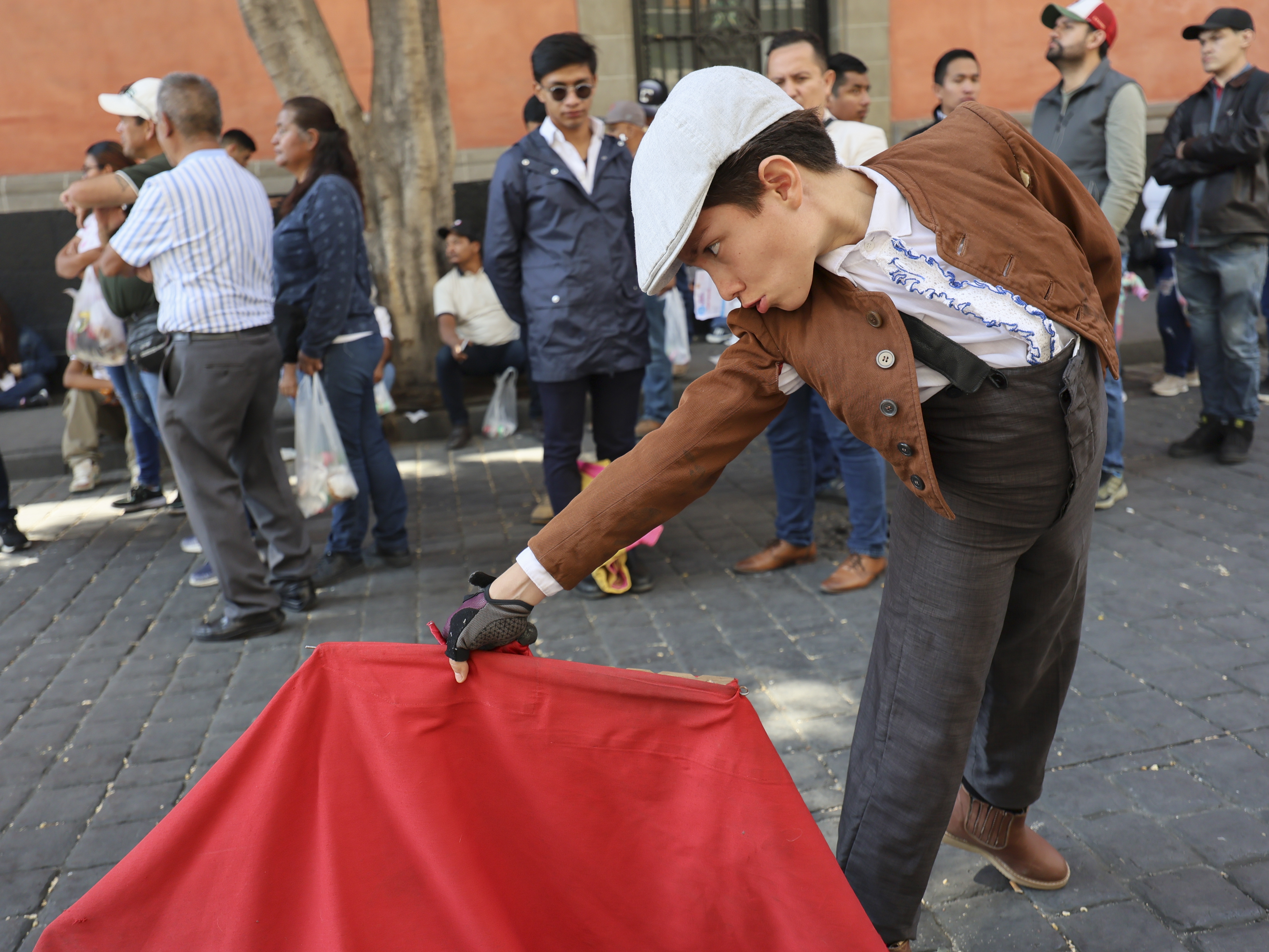 caption: A young supporter of bullfighting joins a demonstration in support of bullfighting outside Mexico City's Congress where lawmakers are expected to debate its continuation in Mexico City on Tuesday.