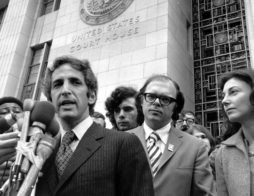 caption: Daniel Ellsberg (left) and co-defendant Anthony Russo talk to news reporters outside the Federal Building in Los Angeles on Jan. 17, 1973, during the Pentagon Papers trial.
