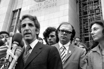 caption: Daniel Ellsberg (left) and co-defendant Anthony Russo talk to news reporters outside the Federal Building in Los Angeles on Jan. 17, 1973, during the Pentagon Papers trial.