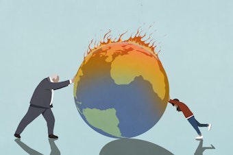 Stock image of a businessman and a girl pushing a burning globe.