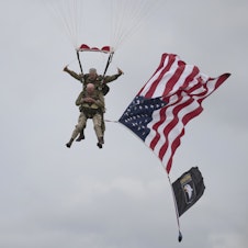 caption: U.S. World War II D-Day veteran Tom Rice, from Coronado, Calif., parachutes in a tandem jump into a field in Carentan, Normandy, France, on Wednesday. Approximately 200 parachutists participated in the event, replicating a jump made by U.S. soldiers on June 6, 1944 — D-Day.
