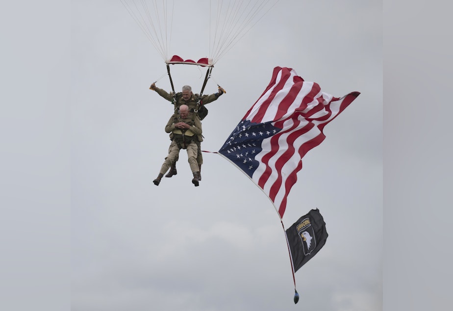 caption: U.S. World War II D-Day veteran Tom Rice, from Coronado, Calif., parachutes in a tandem jump into a field in Carentan, Normandy, France, on Wednesday. Approximately 200 parachutists participated in the event, replicating a jump made by U.S. soldiers on June 6, 1944 — D-Day.