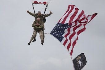 caption: U.S. World War II D-Day veteran Tom Rice, from Coronado, Calif., parachutes in a tandem jump into a field in Carentan, Normandy, France, on Wednesday. Approximately 200 parachutists participated in the event, replicating a jump made by U.S. soldiers on June 6, 1944 — D-Day.