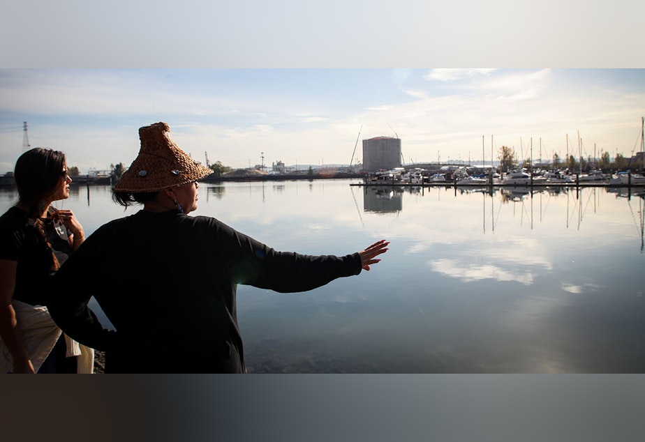 caption: Tribal members on Tacoma's Hylebos Waterway with the Puyallup tribal marina and Tacoma LNG plant in the background.