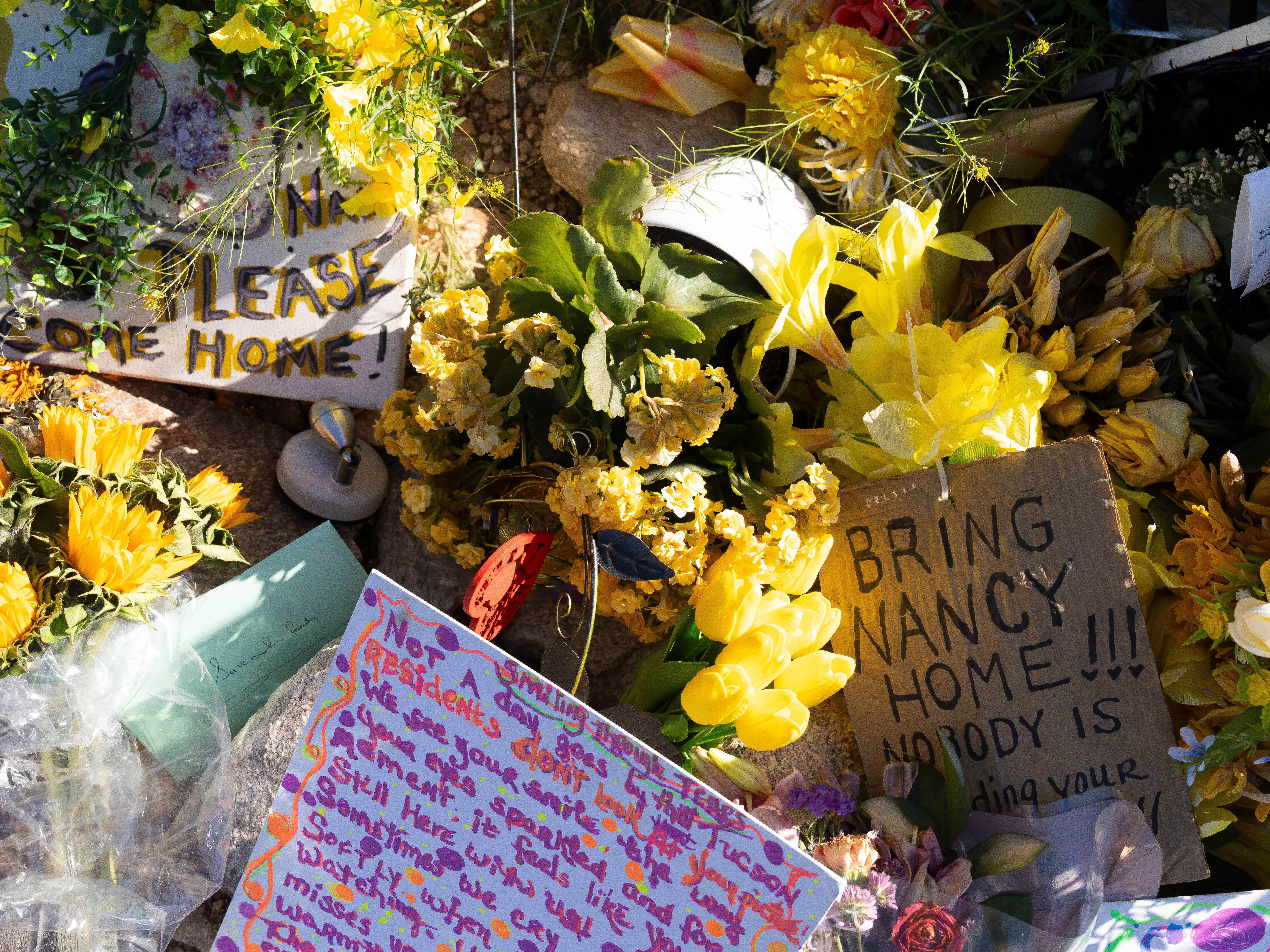 caption: Yellow flowers and handwritten notes calling for the return of Nancy Guthrie sit outside the house of the 84-year-old mother of <em>Today</em> show co-host Savannah Guthrie, in Tucson, Ariz. Savannah Guthrie is speaking about her mother in an emotional two-part interview.