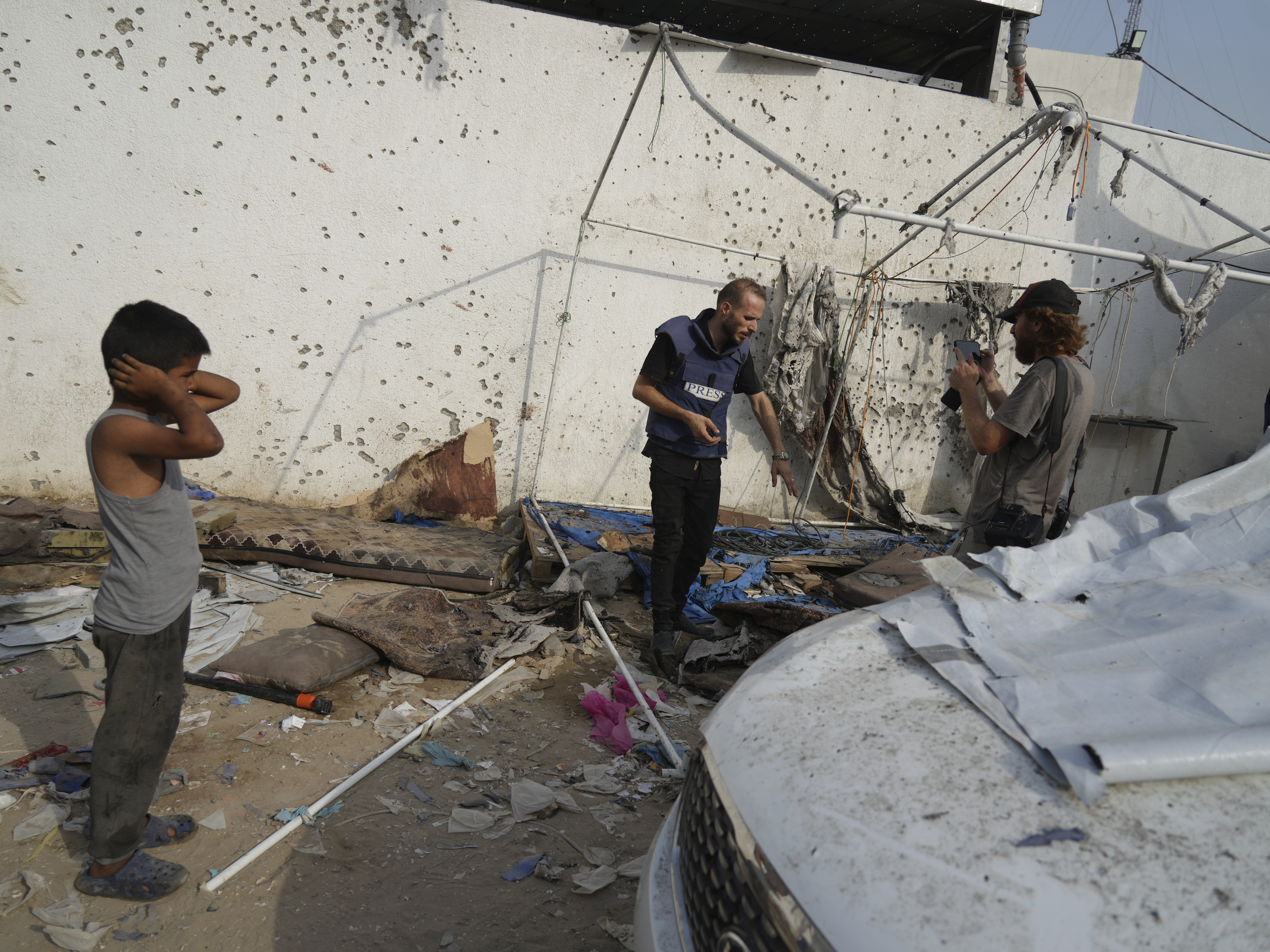 caption: Palestinians inspect on Monday, Aug. 11, 2025, the destroyed tent where journalists, including Al Jazeera correspondents Anas al-Sharif and Mohamed Qureiqa were killed by an Israeli airstrike outside the Gaza City's Shifa hospital complex.