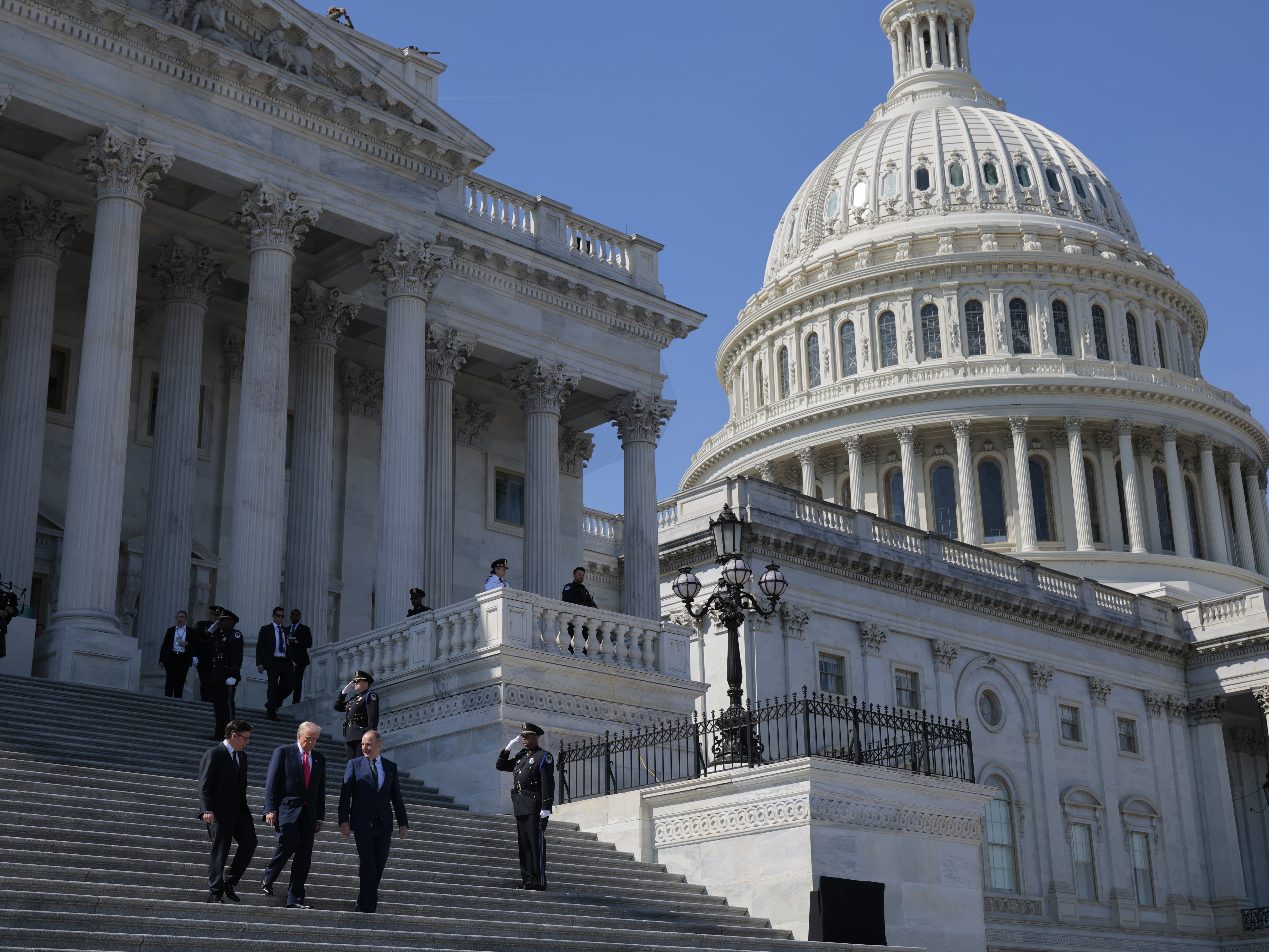 caption: A view of the U.S. Capitol as (L-R) House Speaker Mike Johnson (R-LA), U.S. President Donald Trump and Irish Taoiseach Micheál Martin depart a luncheon on March 12, 2025 in Washington, DC.