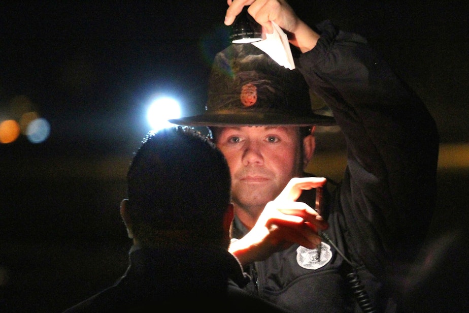 caption: WA State trooper conducts sobriety test