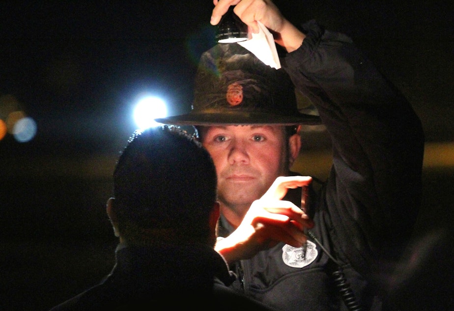caption: WA State trooper conducts sobriety test