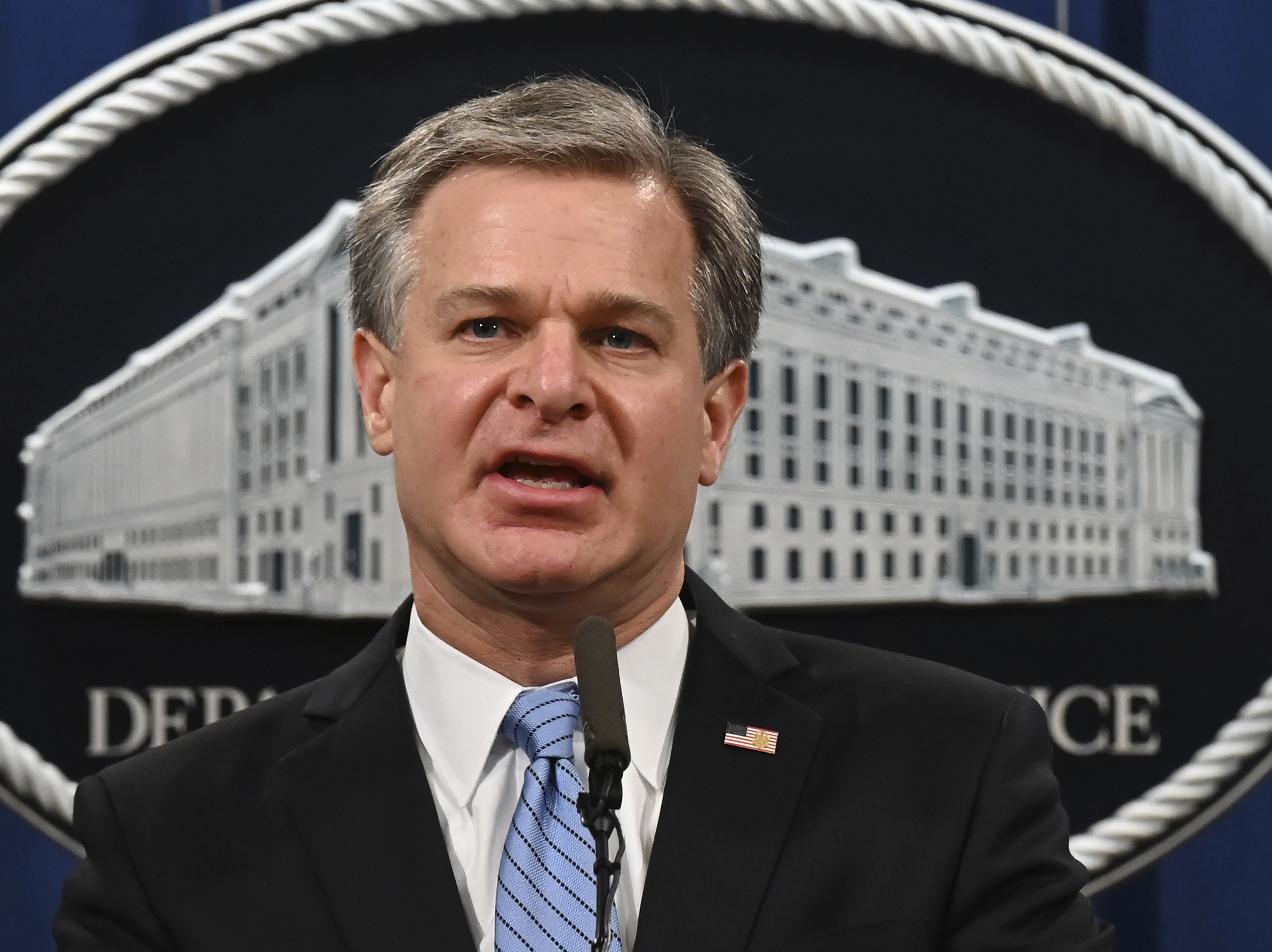 caption: FBI Director Christopher Wray speaks during a press conference this month at the Department of Justice.