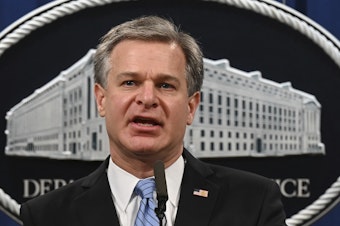 caption: FBI Director Christopher Wray speaks during a press conference this month at the Department of Justice.