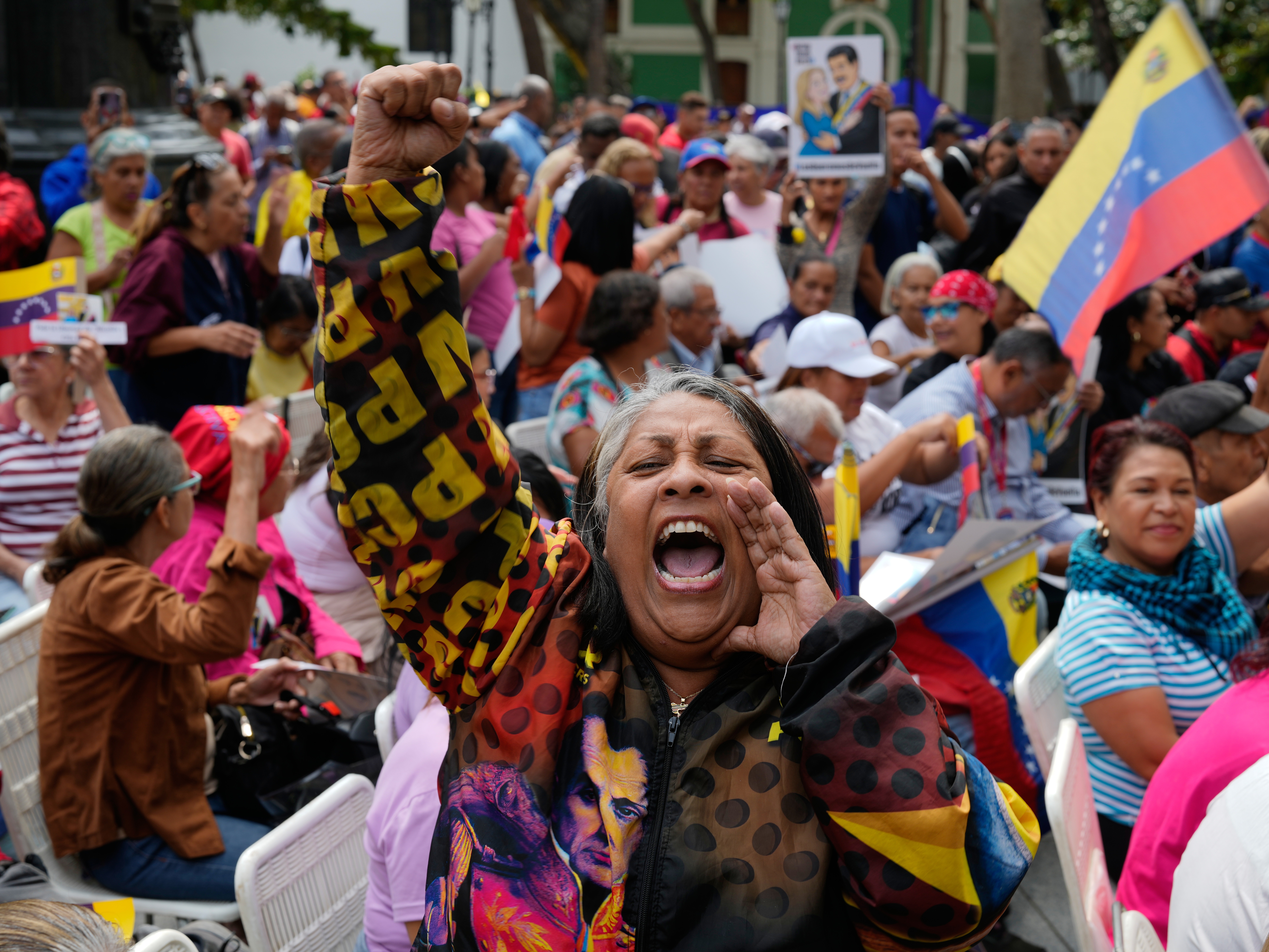 caption: A woman screams during a government-organized event to watch former President Nicolas Maduro and first lady Cilia Flores appear in a New York court on a screen in Caracas, Venezuela, Thursday, March 26, 2026.