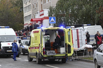 caption: Police and paramedics work at the scene of a shooting at school No. 88 in Izhevsk, Russia, Monday, Sept. 26, 2022. A gunman on Monday morning killed 13 people and wounded 21 others in a school in central Russia, authorities said.
