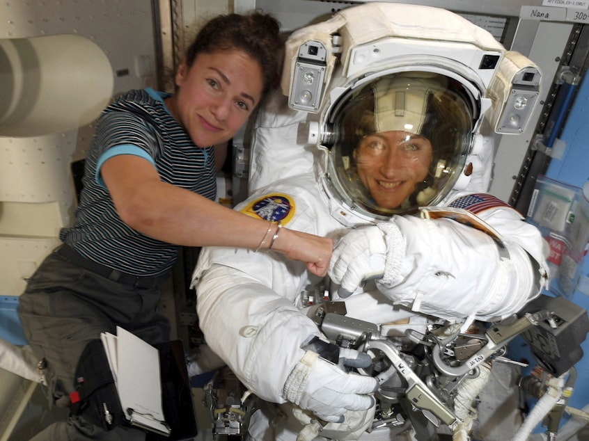 caption: Astronauts Christina Koch (right) and Jessica Meir pose for a photo on the International Space Station on Oct. 4. NASA moved up the first all-female spacewalk because of a power system failure at the space station.