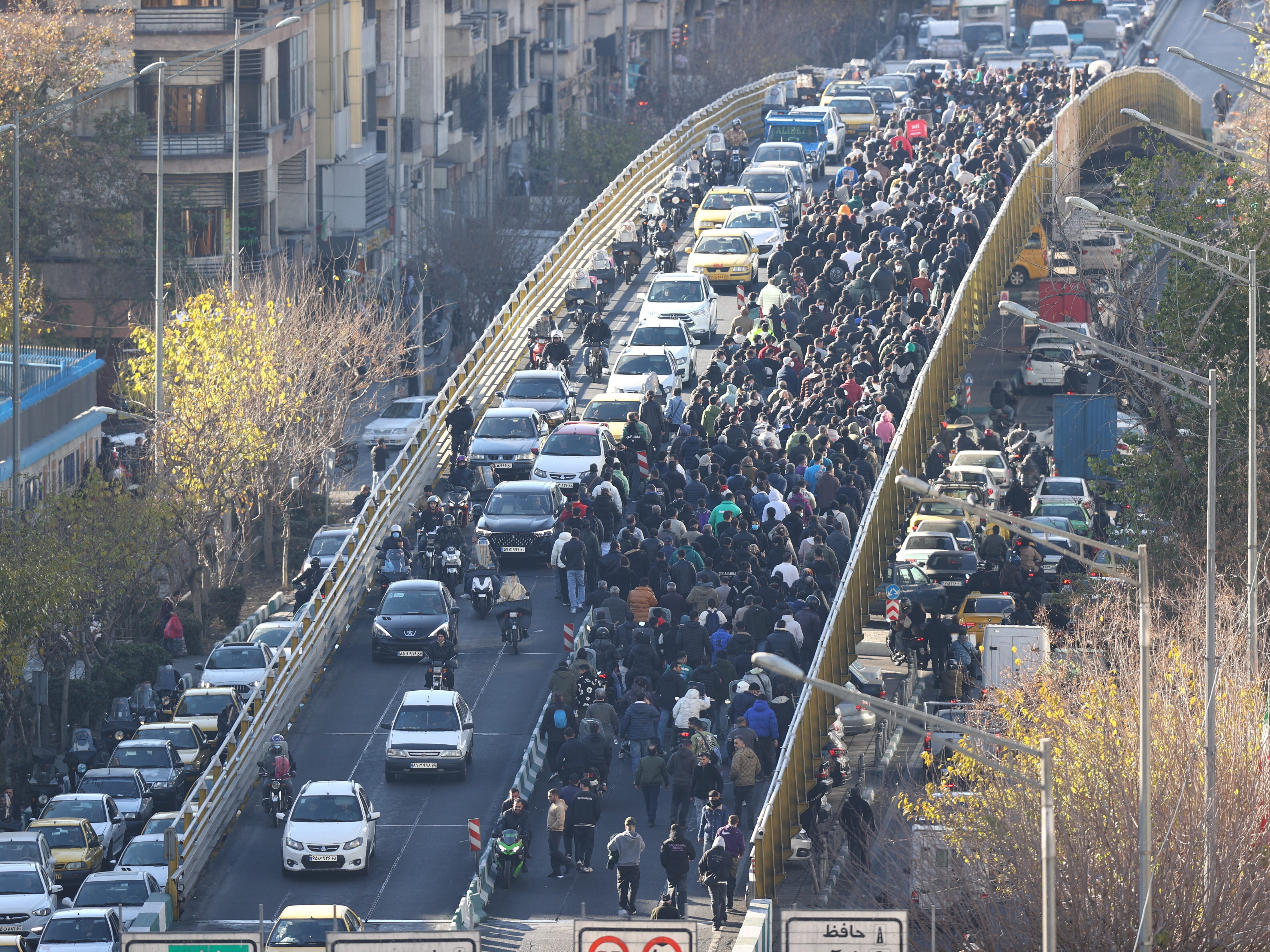 caption: Protesters march on a bridge in Tehran, Iran, on Dec. 29, 2025.