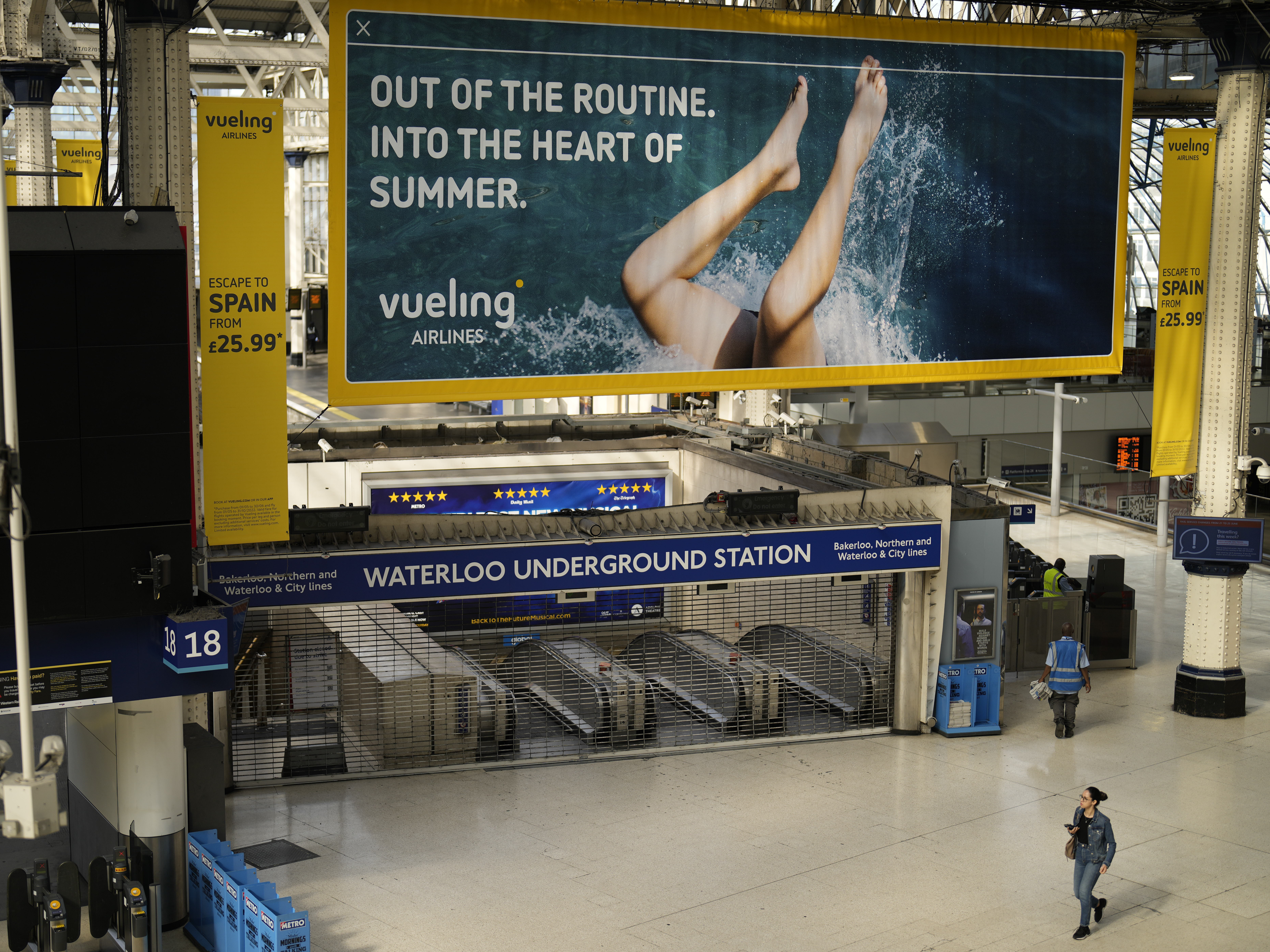 caption: An entrance to Waterloo underground station stands shuttered closed for strike action in Waterloo railway station, in London, Tuesday, June 21, 2022.