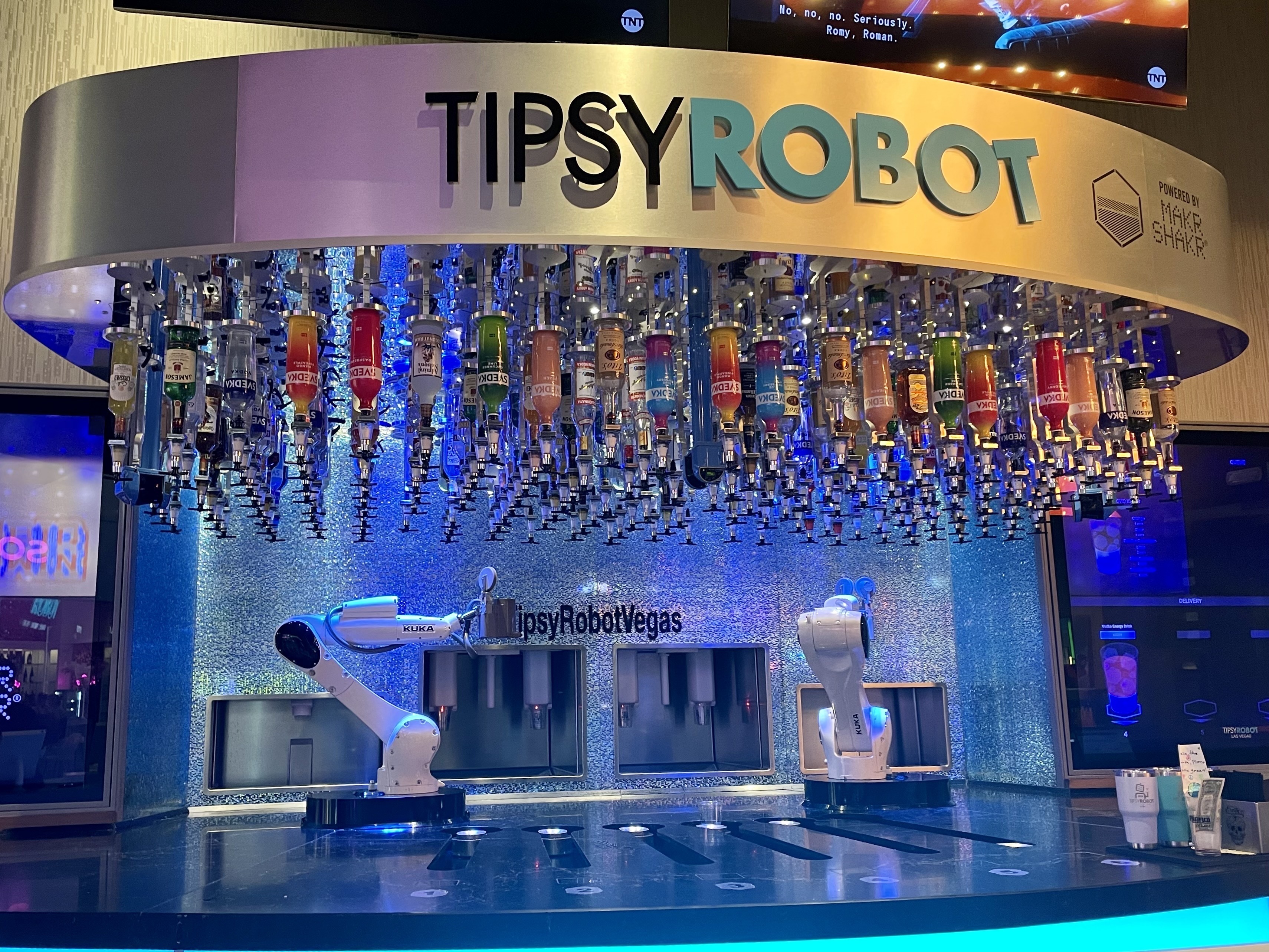caption: This bar inside Planet Hollywood on the Las Vegas strip has two robots that serve customers drinks. The Tipsy Robot opened a second location on the strip this year.